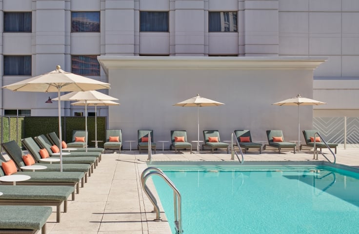 Lounge chairs surrounding the pool at the Camby