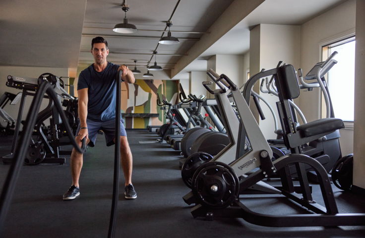 A man working out in the gym at the Camby