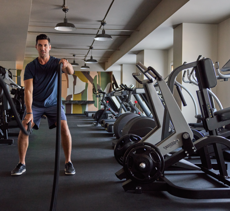 A man working out in the gym at the Camby
