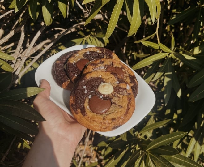 4 Chocolate cookies on a plate outside from Cartel Coffee Roasters