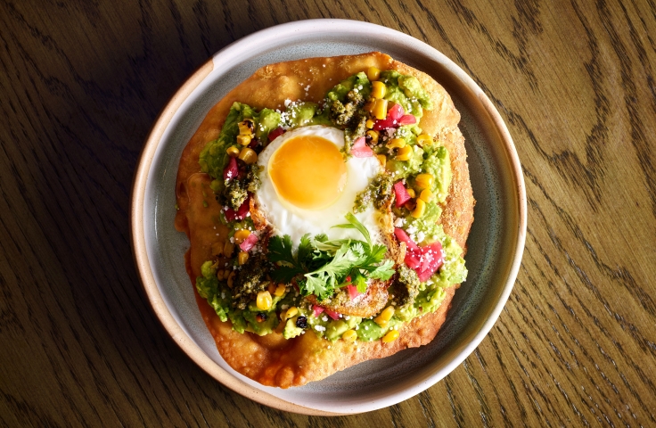 Fried bread with avocado and a sunny side up egg at Yellowbell