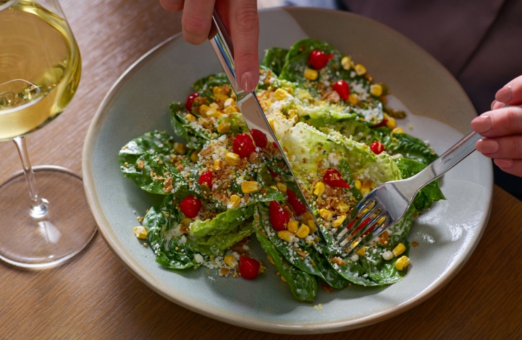 A salad with corn and romaine lettuce at Yellowbell