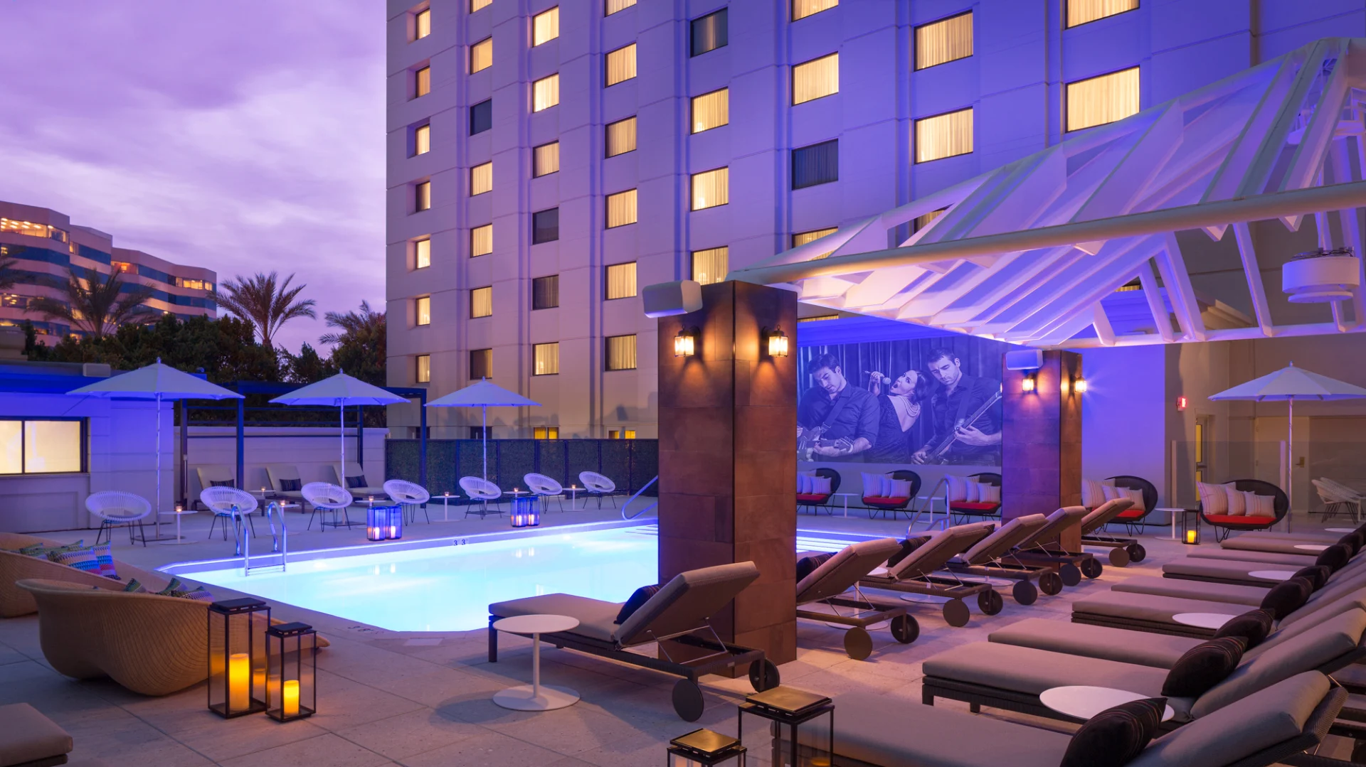 Rooftop pool area at night at the Camby