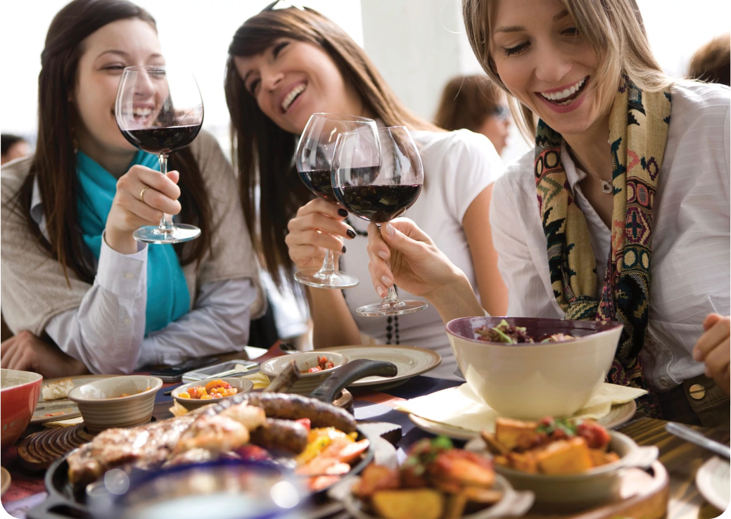Women having glasses of red wine and food Yellowbell