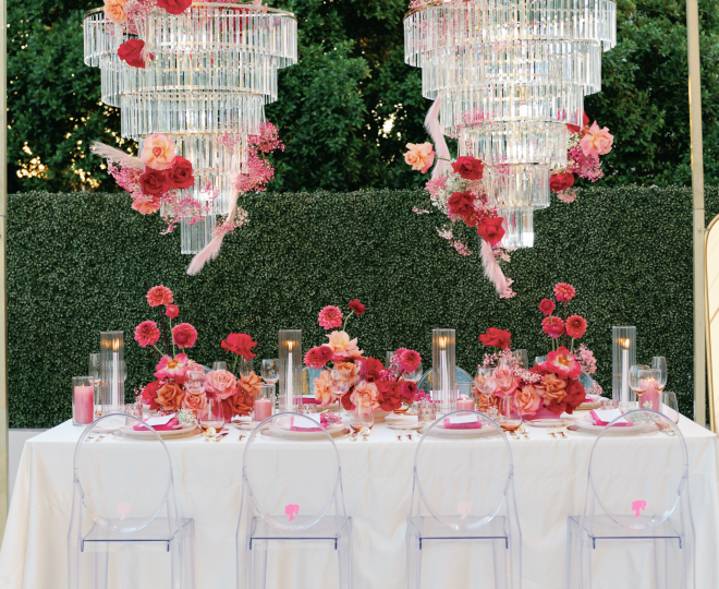 2 large chandeliers above a table at an outdoor wedding venue at the Camby