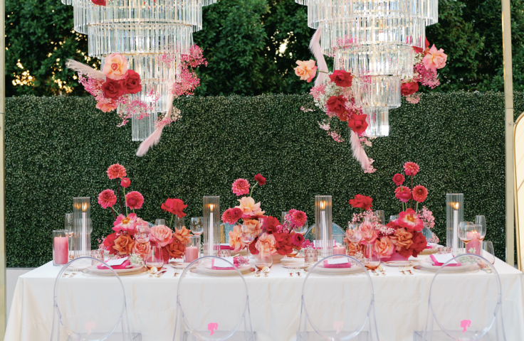 2 large chandeliers above a table at an outdoor wedding venue at the Camby