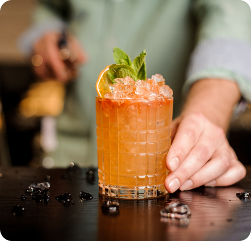 A crushed ice cocktail with an orange slice at Yellowbell