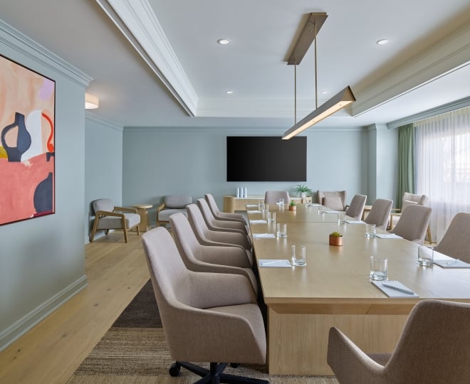 An indoor meeting space at the Camby with a long table and chairs