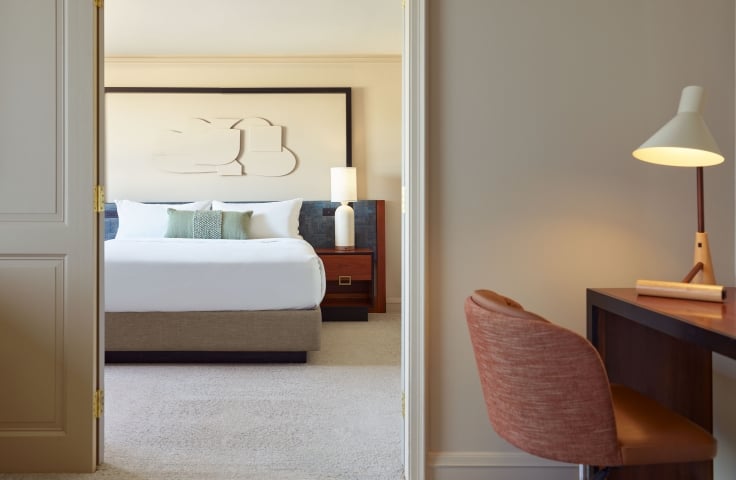 Bedroom and desk area of the Uptown Suite at the Camby