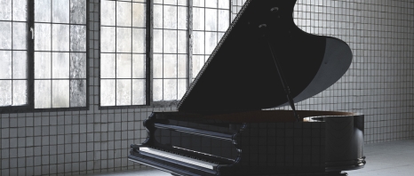 A piano in a beautiful tiled room at the Musical Instrument Museum