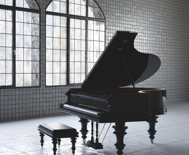 A piano in a beautiful tiled room at the Musical Instrument Museum