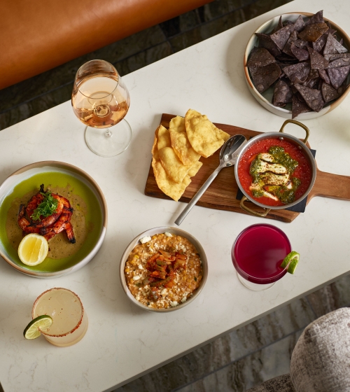 A spread of food and cocktails Yellowbell at the Camby