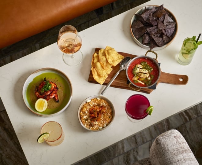 A spread of food and cocktails Yellowbell at the Camby