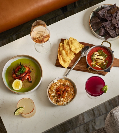 A spread of food and cocktails Yellowbell at the Camby