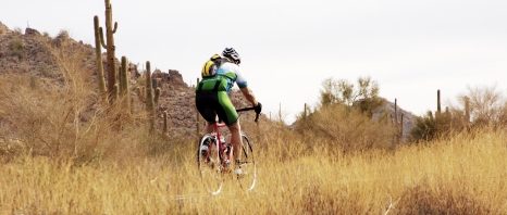 A man biking through the outback of Arizona