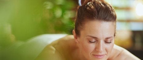 A woman relaxing on a spa bed at the Four Seasons