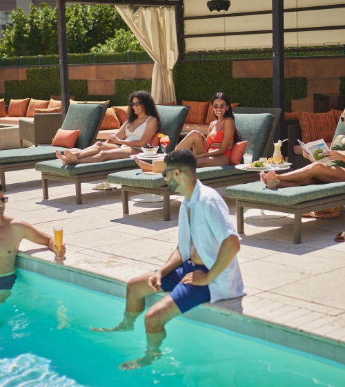 The Camby rooftop pool, people socializing, cabanas, beer