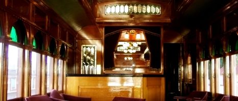 A Victorian parlor car on a train.