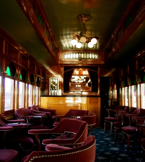 A Victorian parlor car on a train.