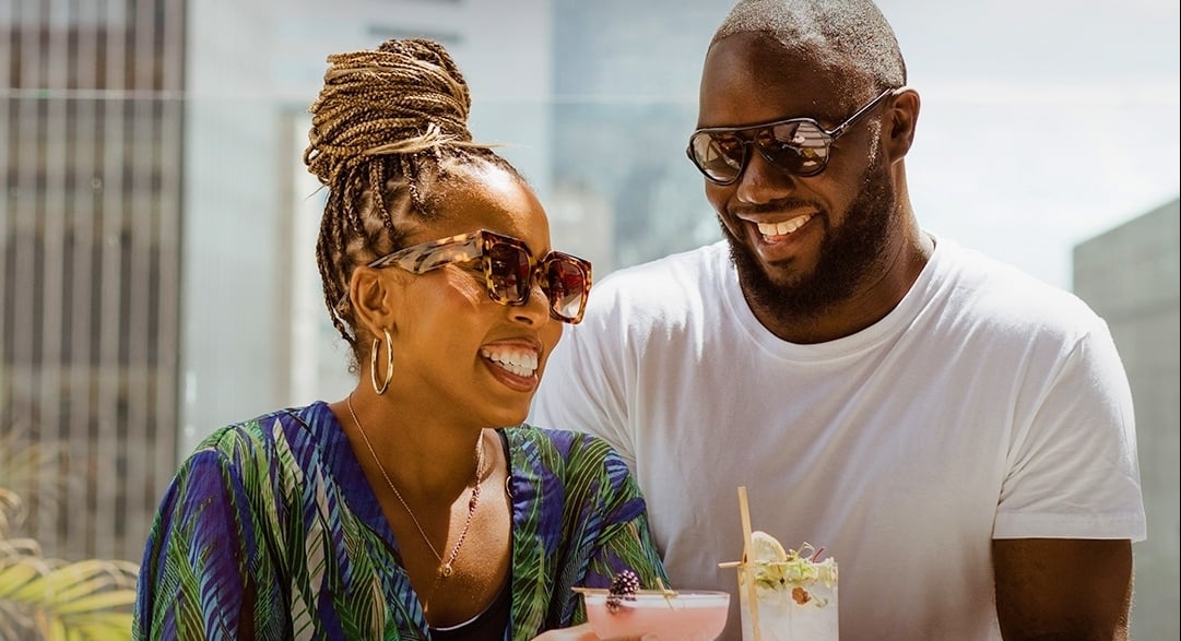 Couple with cocktails on rooftop