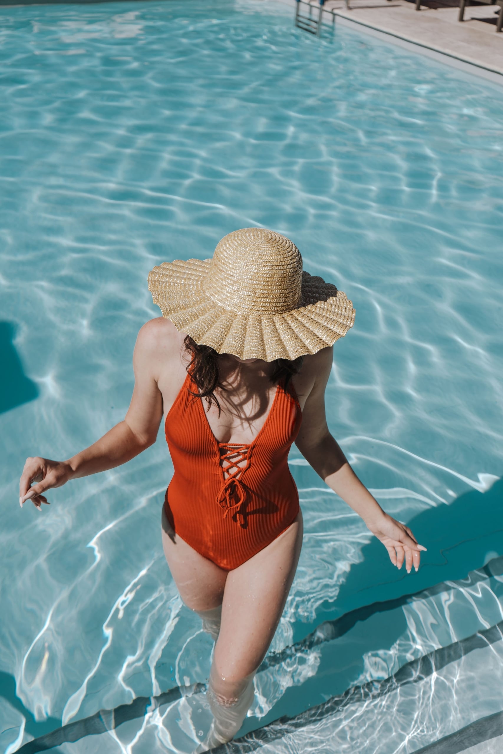 Camby Rooftop pool, red swimsuit, sun hat, swimming, woman